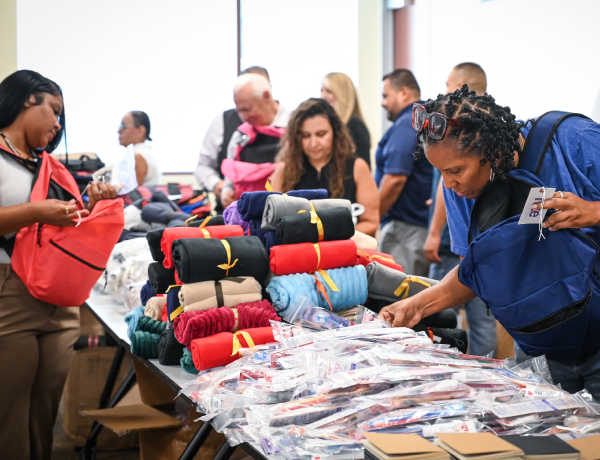 team members packing backpacks for foster youth