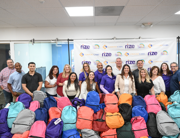 team members and backpacks for foster youth