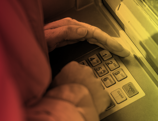 hand covering ATM keypad