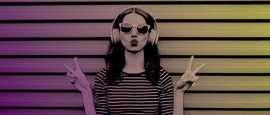 girl wearing headphones showing peace sign