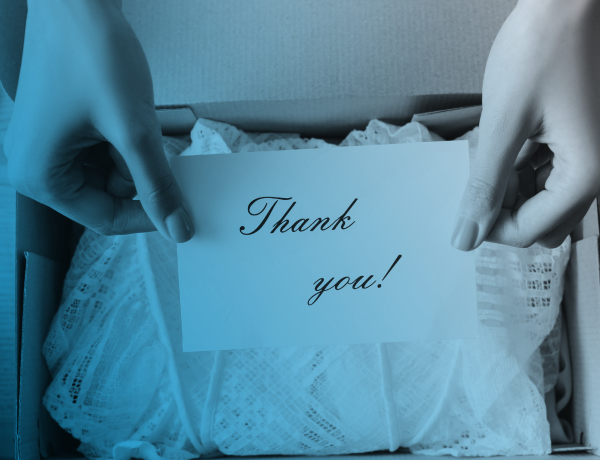business owner putting thank you note in shipping box