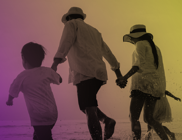 family running in the waves at the beach
