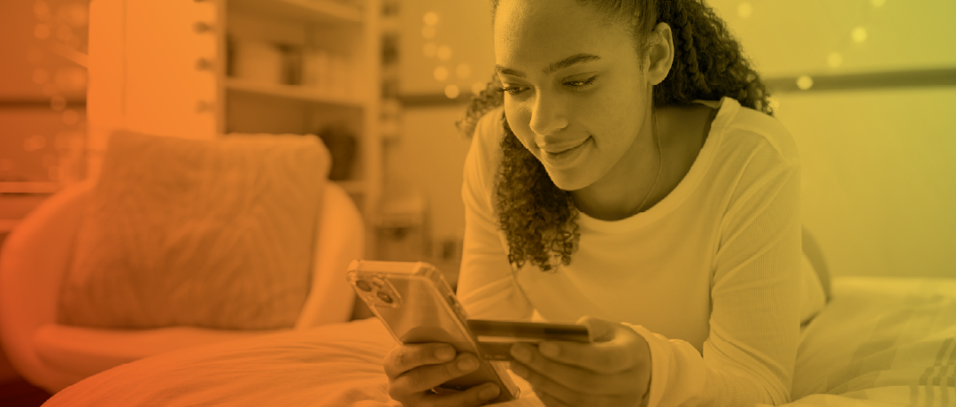 teen girl using credit card on cellphone