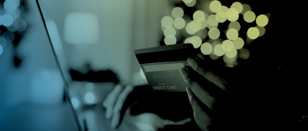 person using credit card on laptop